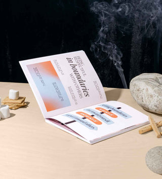 Open journal with text on a table with incense and stones