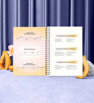 Open book with educational content on a blue textured surface with pumpkins and a candle.